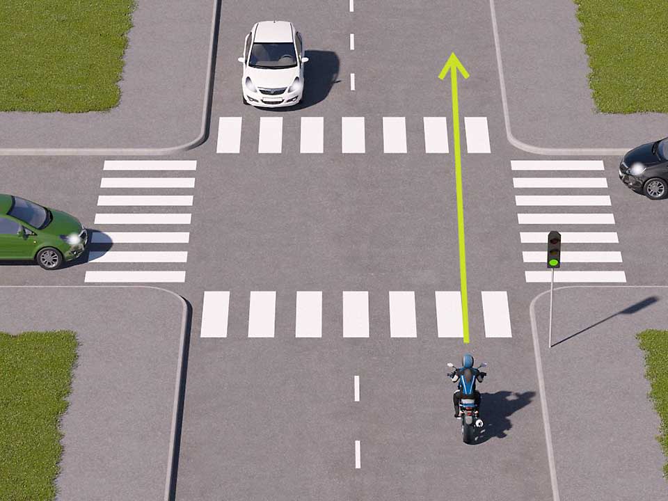 mallinnettu liikennetilanne, jossa moottoripyöräilijä lähestyy valo-risteystä